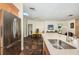 Bright kitchen with stainless steel sink, quartz countertops, and an open layout to the dining room at 12873 Cumberland Dr, Largo, FL 33773