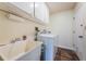Laundry room featuring a sink, washing machine, and dryer at 12873 Cumberland Dr, Largo, FL 33773