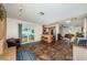 Expansive living area showcasing a kitchen, dining area, and an airy living room with sliding doors to the outdoor patio at 12873 Cumberland Dr, Largo, FL 33773