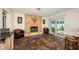 Comfortable living room featuring a tiled fireplace, plush seating, and sliding door access to the screened patio at 12873 Cumberland Dr, Largo, FL 33773