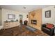 Cozy living room with a tiled fireplace, accent chairs, and a nearby bedroom for added convenience at 12873 Cumberland Dr, Largo, FL 33773