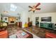Spacious living room offering tile floors, a ceiling fan, comfortable seating and access to other rooms at 12873 Cumberland Dr, Largo, FL 33773