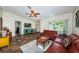 Spacious living room boasts comfortable seating, a ceiling fan and an expansive view to the outdoor scenery at 12873 Cumberland Dr, Largo, FL 33773