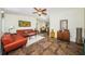 Cozy living room boasts a ceiling fan, skylight, comfortable furniture and access to the dining area at 12873 Cumberland Dr, Largo, FL 33773