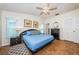 Bright main bedroom features a ceiling fan, wood floors, and ensuite bath at 12873 Cumberland Dr, Largo, FL 33773