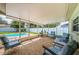 Inviting screened patio with brick flooring and comfortable seating by the pool, perfect for outdoor enjoyment at 12873 Cumberland Dr, Largo, FL 33773