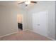 Bedroom featuring a ceiling fan, a closet and access to an ensuite bathroom at 13111 Pepper Stem St, Spring Hill, FL 34609