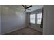 Cozy bedroom features two windows, plush carpet, and a ceiling fan at 13111 Pepper Stem St, Spring Hill, FL 34609