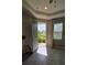 Open entryway with neutral walls, tile floors, natural light and space for welcoming guests at 13111 Pepper Stem St, Spring Hill, FL 34609