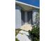Exterior doors with painted trim surrounded by green shrubbery and lawn at 13111 Pepper Stem St, Spring Hill, FL 34609