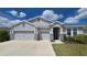 Charming single-story home with a three-car garage and stone accents at 13111 Pepper Stem St, Spring Hill, FL 34609