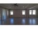 A spacious living room with tiled floors, recessed lights, tray ceilings, and large windows that fill the space with natural light at 13111 Pepper Stem St, Spring Hill, FL 34609