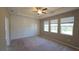 A bedroom features a tray ceiling, ceiling fan, and decorative wall trim, creating a stylish and comfortable retreat at 13111 Pepper Stem St, Spring Hill, FL 34609