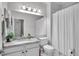 Bathroom with white vanity, generous mirror and combination tub shower at 13336 Graham Yarden Dr, Riverview, FL 33579