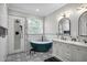 Spa-like primary bathroom with dual vanity, modern shower, and freestanding tub at 13336 Graham Yarden Dr, Riverview, FL 33579