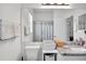 Bright bathroom featuring a toilet and granite countertop vanity with a large mirror at 13336 Graham Yarden Dr, Riverview, FL 33579