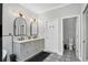 Bright primary bath with double sinks, decorative mirrors, and adjacent toilet room at 13336 Graham Yarden Dr, Riverview, FL 33579