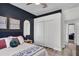 Bedroom with closet, accent wall and view into common area at 13336 Graham Yarden Dr, Riverview, FL 33579