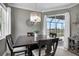 Elegant dining area with dark wood table, chandelier, and views of the screened-in patio at 13336 Graham Yarden Dr, Riverview, FL 33579