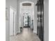 Bright entryway features herringbone floors, arched ceilings, and a decorative sliding barn door at 13336 Graham Yarden Dr, Riverview, FL 33579