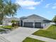 Well-maintained home featuring a three-car garage and attractive landscaping at 13336 Graham Yarden Dr, Riverview, FL 33579
