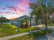 Beautifully landscaped home with a three-car garage near a serene lake at 13336 Graham Yarden Dr, Riverview, FL 33579