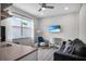 Versatile flex space with a window, desk, sofa, and TV, perfect for an office or den at 13336 Graham Yarden Dr, Riverview, FL 33579