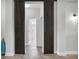 Hallway with decorative sliding barn doors leading to a bathroom, showcasing the home's unique design elements at 13336 Graham Yarden Dr, Riverview, FL 33579