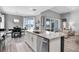 Bright and airy kitchen featuring a large island, breakfast bar, and view of outdoor patio at 13336 Graham Yarden Dr, Riverview, FL 33579