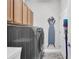 Laundry room featuring gray front load washer/dryer and storage cabinets above at 13336 Graham Yarden Dr, Riverview, FL 33579