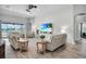 Bright, spacious living room with modern decor, large windows with a lake view, and comfortable seating at 13336 Graham Yarden Dr, Riverview, FL 33579