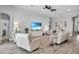 Bright living room featuring shiplap wall, white furniture, ceiling fan, and wood-look tile at 13336 Graham Yarden Dr, Riverview, FL 33579