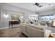 Open living space with wood-look tile, neutral color scheme, and comfortable seating arrangement at 13336 Graham Yarden Dr, Riverview, FL 33579