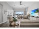 Spacious living room with a shiplap accent wall, large windows with a water view, and modern furnishings at 13336 Graham Yarden Dr, Riverview, FL 33579