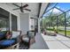 Inviting screened patio with wicker seating, fire pit, and serene views of the outdoors at 13336 Graham Yarden Dr, Riverview, FL 33579