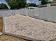 A backyard featuring shell landscaping and a white privacy fence at 14530 Apache Ave, Largo, FL 33774