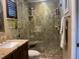 Contemporary bathroom featuring a glass shower, glass shelving, and granite counters at 14530 Apache Ave, Largo, FL 33774