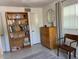 Bright bedroom with a bookcase, dresser and a chair in a neutrally decorated space at 14530 Apache Ave, Largo, FL 33774