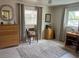 Well-lit bedroom with a neutral color scheme, dresser, rug and two large windows at 14530 Apache Ave, Largo, FL 33774
