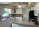 Bright kitchen featuring white cabinetry, stainless steel appliances, and a functional layout at 14530 Apache Ave, Largo, FL 33774