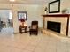 Living room features a stone fireplace, neutral-colored tile flooring and lots of natural light at 14530 Apache Ave, Largo, FL 33774