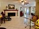 Living room with tile flooring, decorative fireplace with white brick, a glass coffee table and comfortable seating at 14530 Apache Ave, Largo, FL 33774