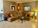 Inviting living room featuring a comfortable sectional sofa, decorative lighting, and an airy atmosphere at 14530 Apache Ave, Largo, FL 33774