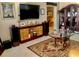 Open-concept living area with a TV, decorative furniture, and a clear view into other rooms at 14530 Apache Ave, Largo, FL 33774