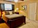 A well-lit room featuring a queen bed, soft carpet and an artistic design at 14530 Apache Ave, Largo, FL 33774