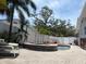 Backyard pool and spa area with brick pavers, white fences, and tropical landscaping at 14530 Apache Ave, Largo, FL 33774