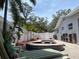 Backyard pool and spa area with brick pavers, white fences, and tropical landscaping at 14530 Apache Ave, Largo, FL 33774
