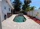 A backyard featuring a private pool, palm trees, brick pavers and updated landscaping at 14530 Apache Ave, Largo, FL 33774