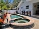 Backyard pool and spa with brick pavers and seating area at 14530 Apache Ave, Largo, FL 33774