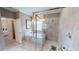 Bathroom showcasing a soaking tub, glass-enclosed shower, and stylish tile work at 15021 Oxford Grey Dr, Lakewood Ranch, FL 34211